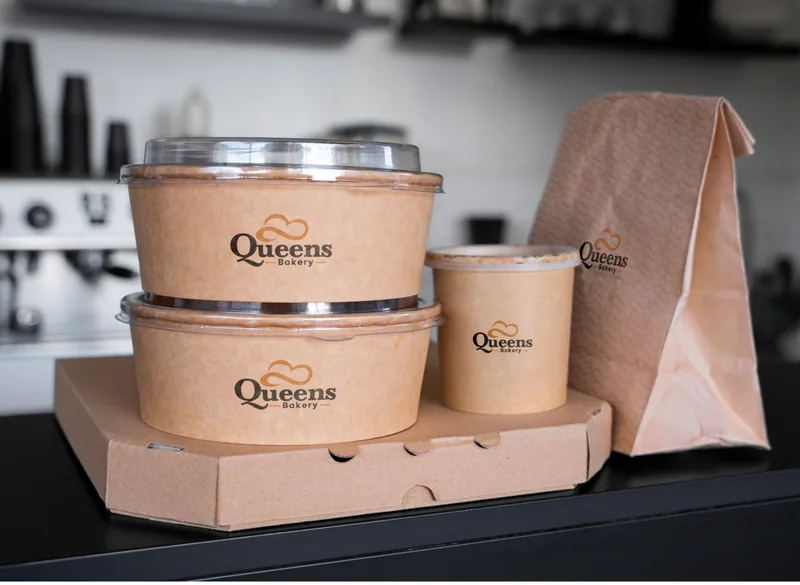 Queens Bakery takeaway cups and cake packaging